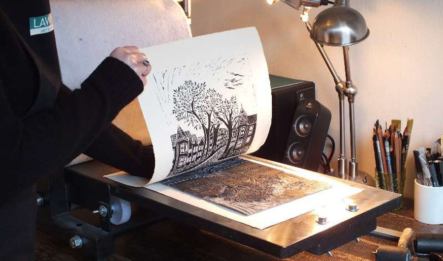peeling the paper from a linocut print